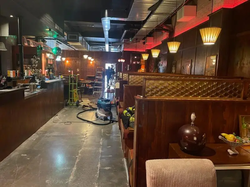 Bar fitout in progress with booth joinery installed and floor preparation under way